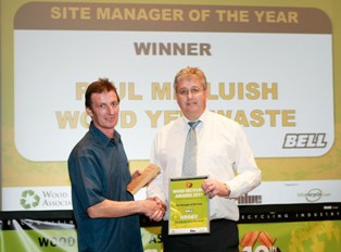 Paul Melluish (left) is presented with his award by Nick Learoyd, UK sales & marketing manager at Bell Machinery
